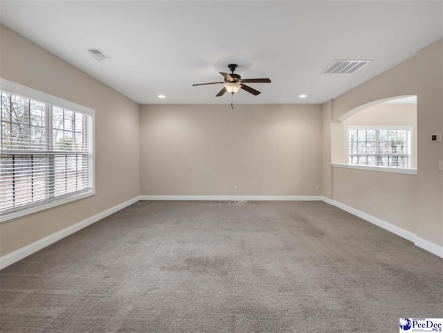 carpeted empty room featuring ceiling fan