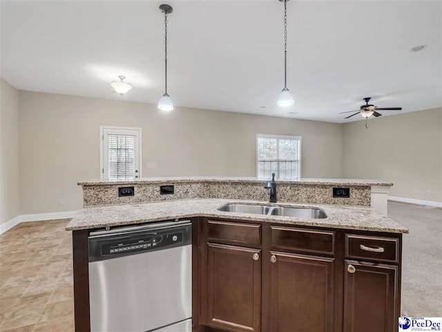 kitchen with sink, plenty of natural light, stainless steel dishwasher, and hanging light fixtures