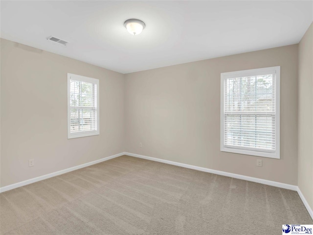 spare room with light colored carpet