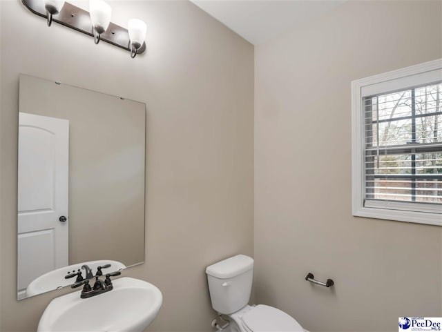 bathroom featuring toilet and sink