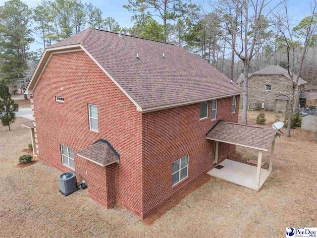 rear view of house featuring central AC and a patio area