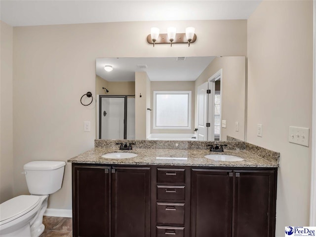 bathroom featuring vanity, toilet, and walk in shower