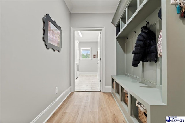 mudroom featuring baseboards and light wood-style floors