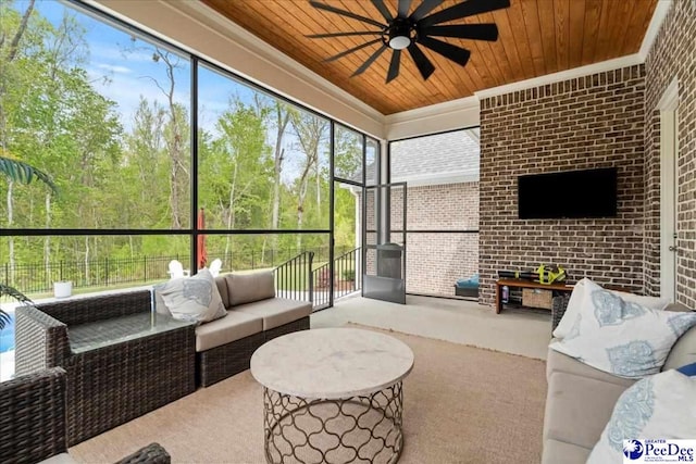 sunroom featuring an outdoor living space and ceiling fan