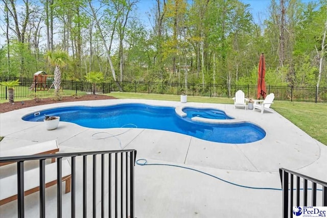 view of pool featuring a fenced backyard, a pool with connected hot tub, a patio area, and a playground