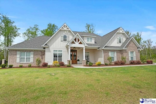 craftsman-style house featuring a front lawn, brick siding, and board and batten siding