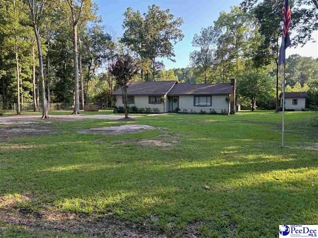 ranch-style home with a front lawn