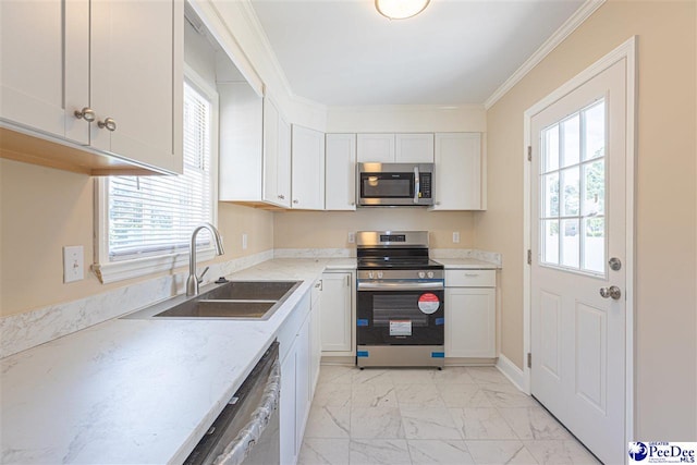 kitchen with sink, crown molding, a wealth of natural light, stainless steel appliances, and white cabinets