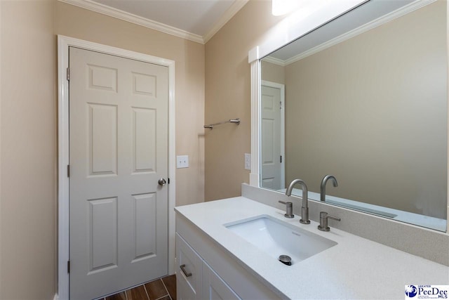 bathroom with hardwood / wood-style flooring, ornamental molding, and vanity