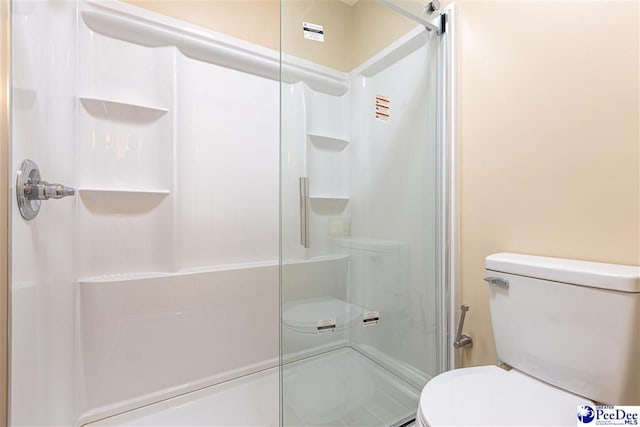 bathroom with toilet and walk in shower