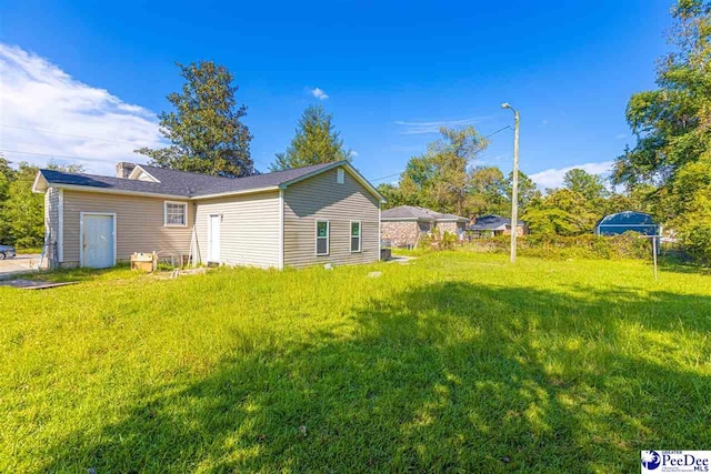 rear view of property with a lawn