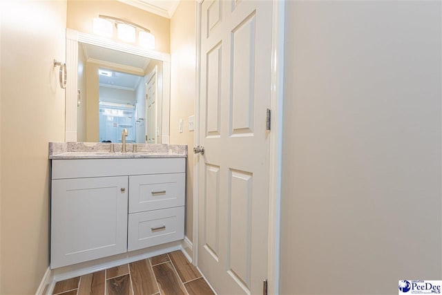 bathroom featuring crown molding and vanity