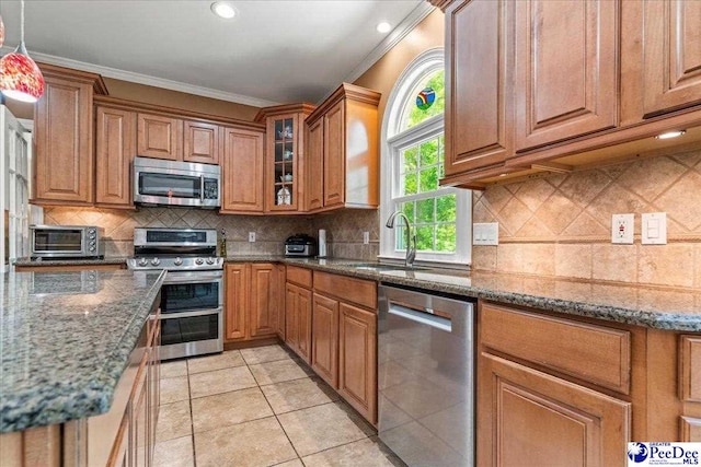 3250 Hampton Pointe Dr, Florence, SC 29501 - kitchen featuring appliances with stainless steel finishes, a sink, crown molding, brown cabinetry, and recessed lighting