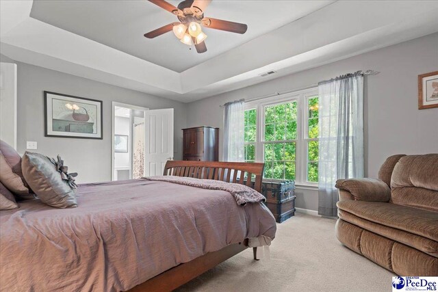 3250 Hampton Pointe Dr, Florence, SC 29501 - bedroom with light carpet, a tray ceiling, and ceiling fan