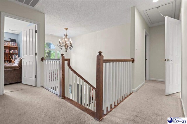 3250 Hampton Pointe Dr, Florence, SC 29501 - corridor with attic access, an upstairs landing, carpet floors, baseboards, and a chandelier