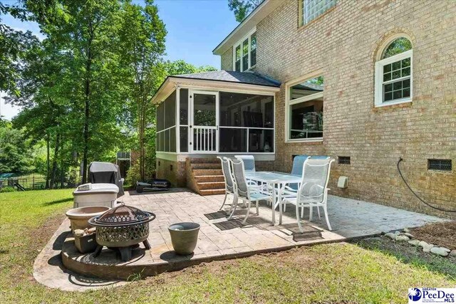 3250 Hampton Pointe Dr, Florence, SC 29501 - view of patio / terrace with a fire pit and a sunroom
