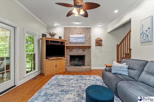 3250 Hampton Pointe Dr, Florence, SC 29501 - living room with wood finished floors, a ceiling fan, stairway, ornamental molding, and a fireplace