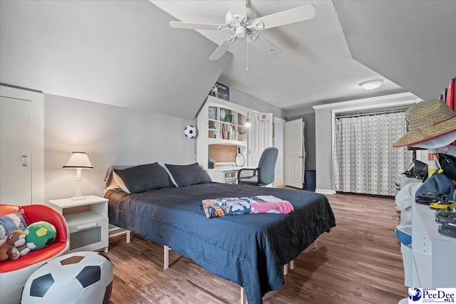 3250 Hampton Pointe Dr, Florence, SC 29501 - bedroom with wood finished floors, lofted ceiling, a textured ceiling, ceiling fan, and baseboards