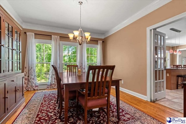 3250 Hampton Pointe Dr, Florence, SC 29501 - dining room featuring a chandelier, light wood-type flooring, ornamental molding, and baseboards