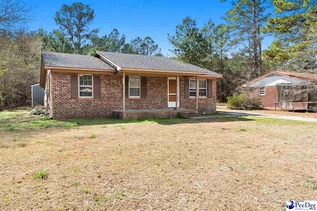 single story home with a trampoline and a front yard