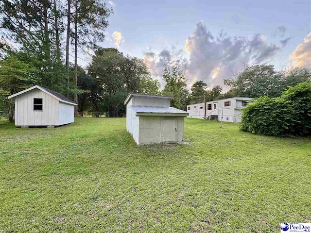 109 Tec Rd, Cheraw, SC 29520 - view of grassy yard with a storage unit and view of scattered trees
