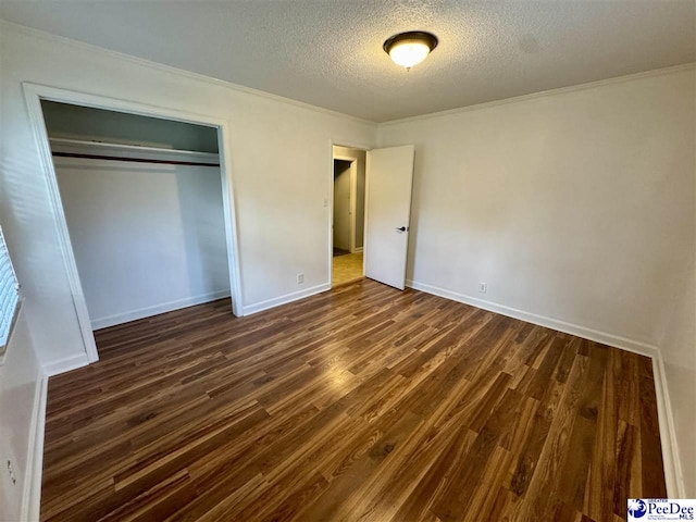 109 Tec Rd, Cheraw, SC 29520 - unfurnished bedroom with a textured ceiling, dark wood finished floors, crown molding, and a closet