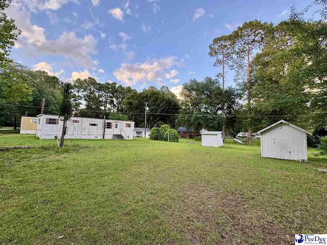 109 Tec Rd, Cheraw, SC 29520 - view of green lawn featuring a storage unit, entry steps, and view of scattered trees