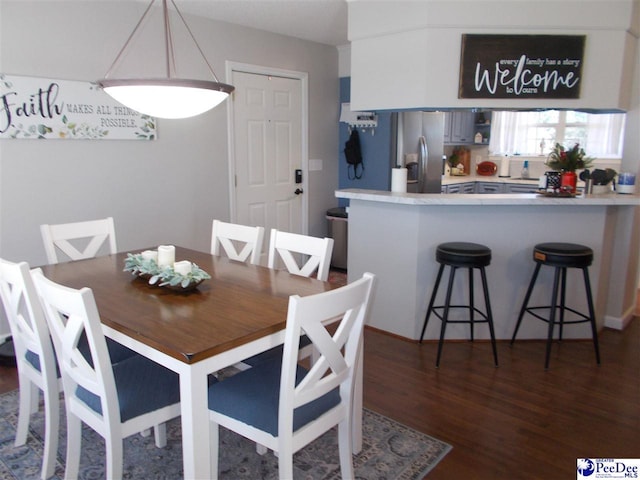 dining room with dark hardwood / wood-style flooring