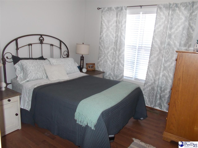 bedroom featuring dark hardwood / wood-style flooring