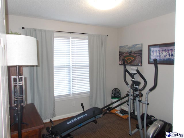 workout room with a textured ceiling