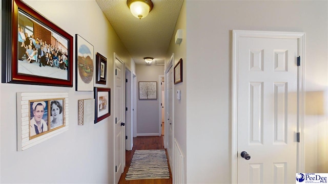 hall with a textured ceiling