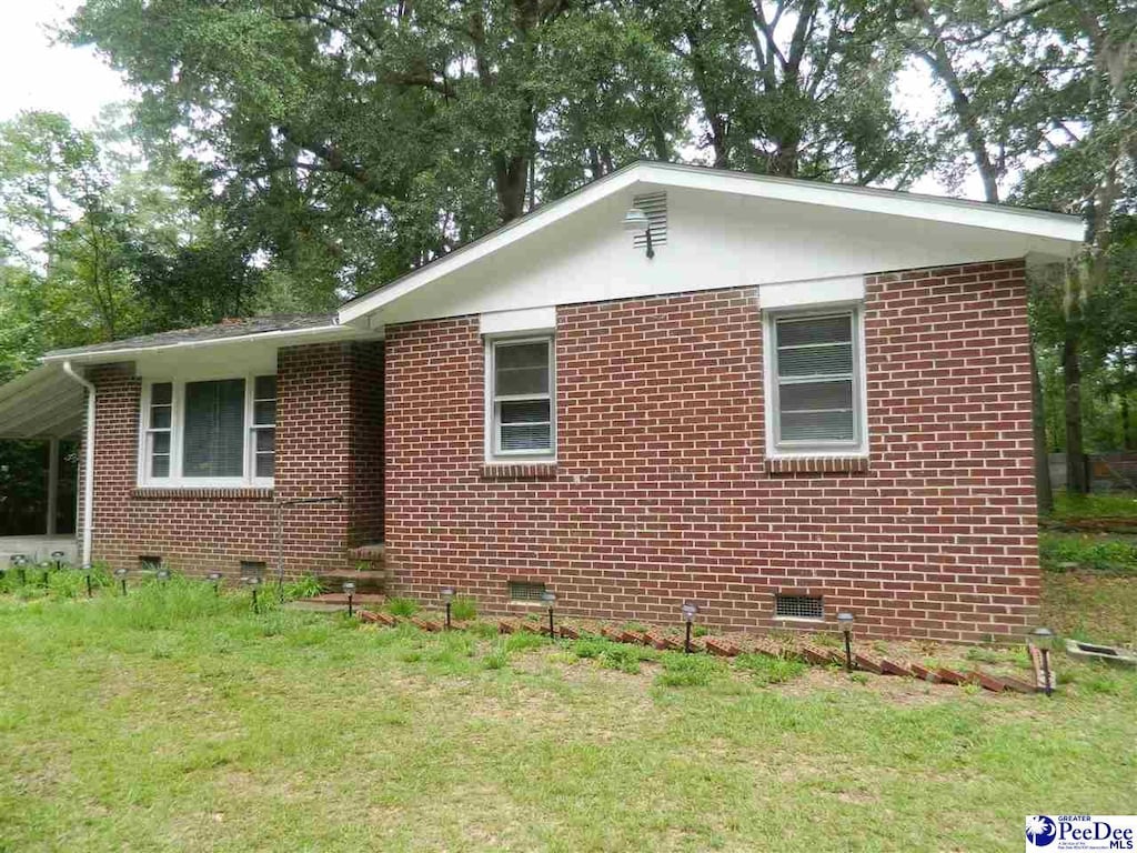 view of home's exterior with a yard