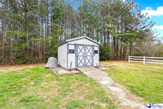 view of outbuilding featuring a yard