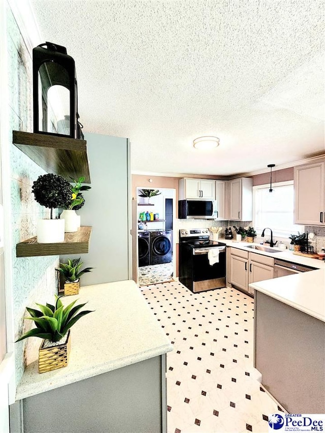 kitchen featuring sink, gray cabinets, stainless steel appliances, separate washer and dryer, and decorative light fixtures