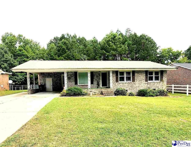 ranch-style house featuring a carport and a front yard