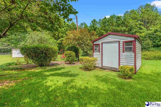 view of outbuilding with a yard