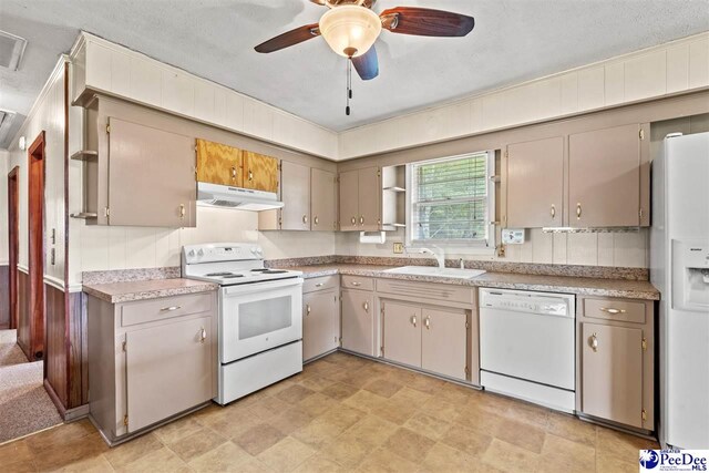 kitchen with ceiling fan, white appliances, sink, and a textured ceiling