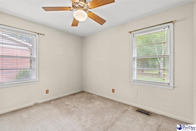 carpeted empty room featuring ceiling fan