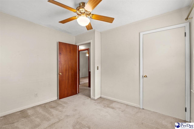 unfurnished bedroom featuring ceiling fan and light carpet