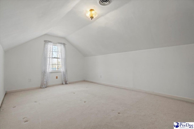 bonus room with lofted ceiling, carpet, visible vents, and baseboards