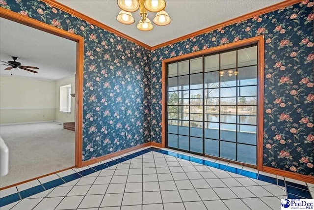 carpeted spare room featuring wallpapered walls, tile patterned flooring, and baseboards