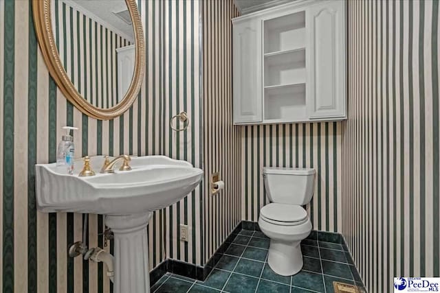 bathroom featuring wallpapered walls, toilet, and tile patterned floors