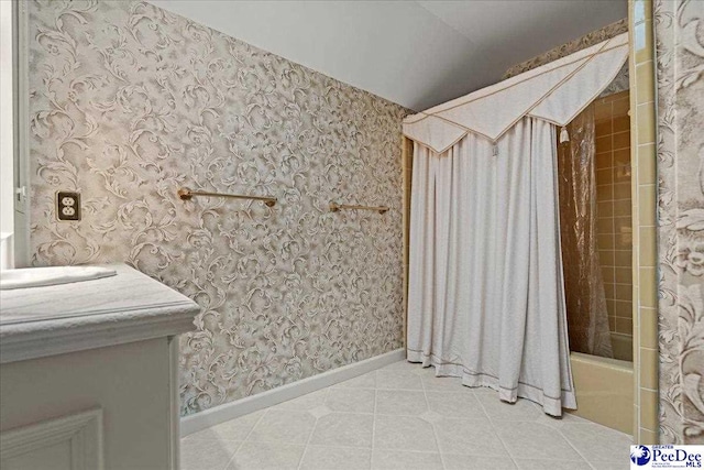 bathroom featuring shower / tub combo, vanity, tile patterned flooring, baseboards, and wallpapered walls