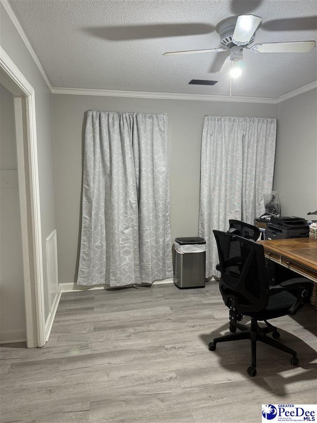 office area featuring ceiling fan, ornamental molding, a textured ceiling, and light wood-type flooring