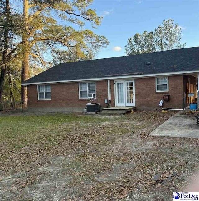 back of house with central AC, a patio, and french doors