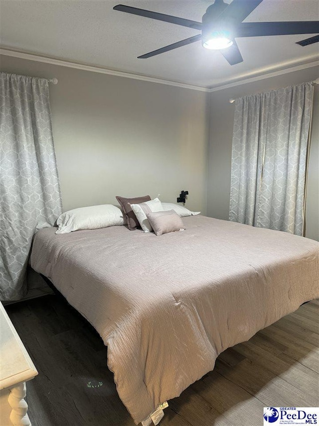 bedroom featuring hardwood / wood-style flooring, ceiling fan, and ornamental molding