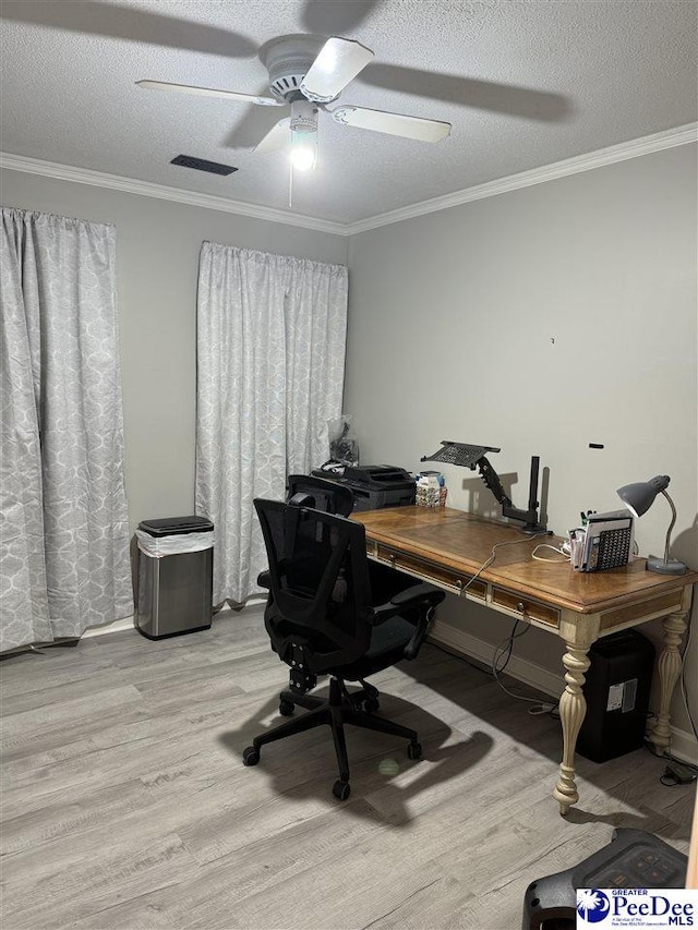 office space featuring crown molding, a textured ceiling, and light wood-type flooring