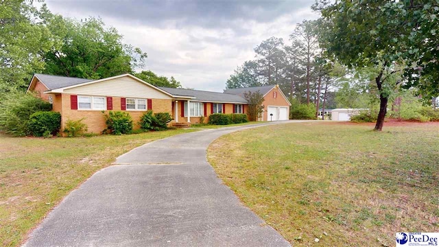 ranch-style house featuring a garage and a front lawn