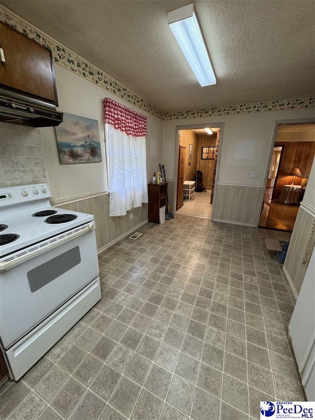 1816 Southern Acres Loop, Dillon, SC 29536 - kitchen with electric range, a textured ceiling, a wainscoted wall, and exhaust hood