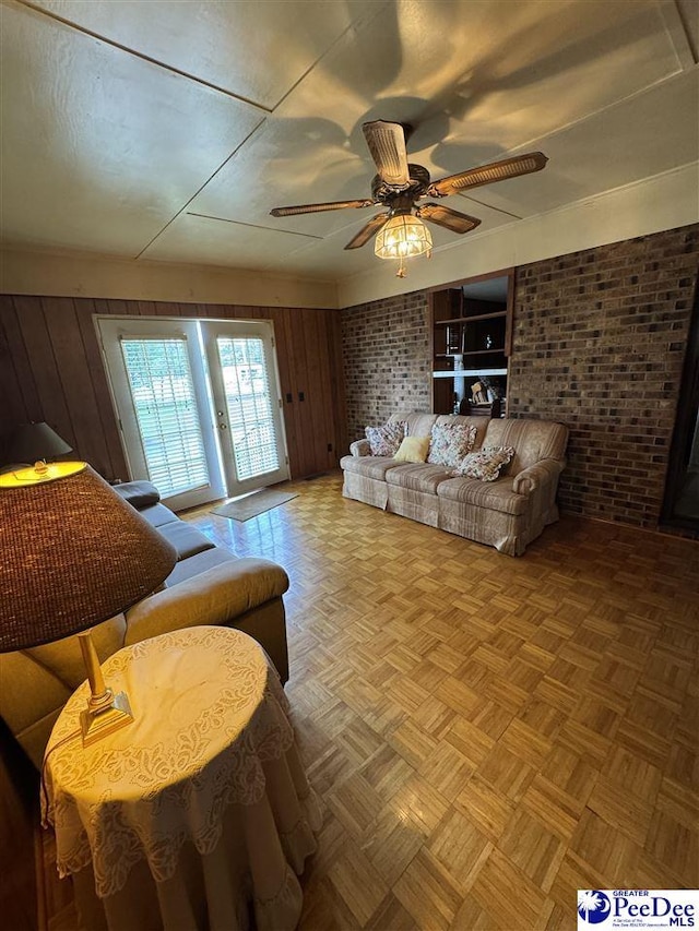 1816 Southern Acres Loop, Dillon, SC 29536 - living area featuring brick wall, ceiling fan, and wooden walls